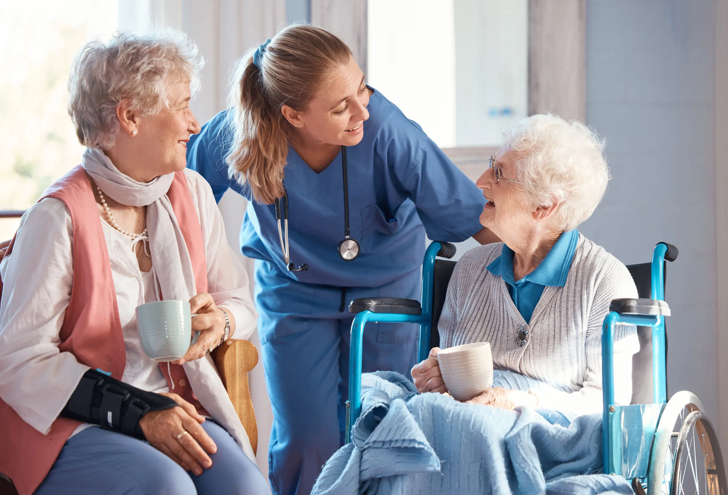 Medical, conversation and elderly woman in wheelchair consulting a doctor at retirement facility Medical, conversation and elderly woman in wheelchair consulting a doctor at retirement facility
