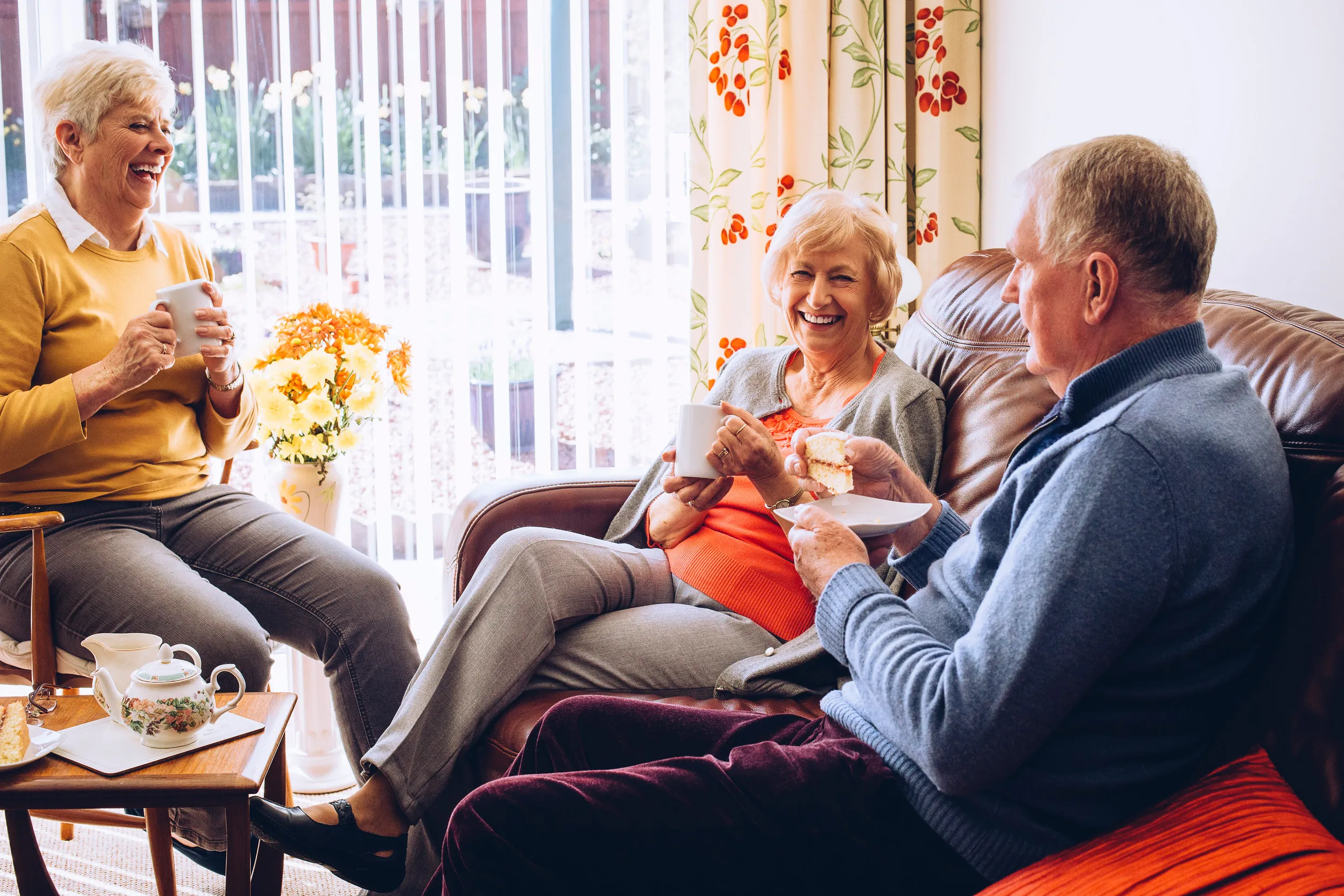 Three seniors enjoying tea and cake in the care home together Three seniors enjoying tea and cake in the care home together